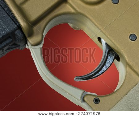 Assault Rifle Trigger With A Red Background Behind
