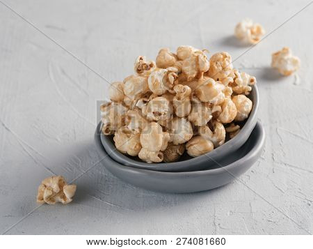 Popcorn In Gray Craft Trendy Plate On Gray Concrete Background. Moovie Background With Copy Space. T