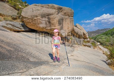 Five Years Old Girl, Adventuress With Cap, Binoculars And Trekking Sticks, Hiking In Rocky Mountain 