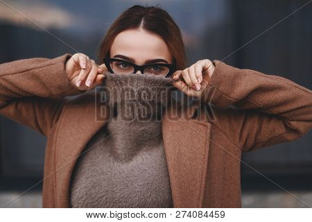 Attractive Woman Walking Near Business Center Windows. Photo Of  Blonde Female Model Looks With Cove