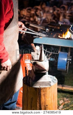 A Craftsman Working With Fire And A Hammer On A Glowing Iron. Middle Age, Flame, Metal, Handmade;