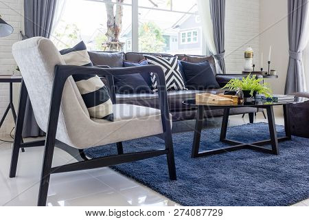 Living Room With Upholstered Furniture, Window Blinds And White Net Curtain