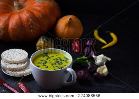Pumpkin Asian Coconat Cream Soup. Autumn Hot Food. Chili Pepper, Garlic, Red Onion, Big Pumpkin. Dar