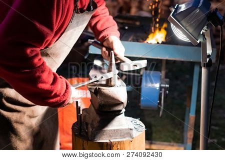 A Craftsman Working With Fire And A Hammer On A Glowing Iron. Middle Age, Flame, Metal, Handmade;