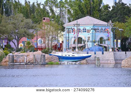 Orlando, Florida. October 19, 2018 Colorful African Style Architecture And  Sailing Boat On Forest B