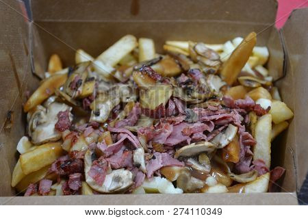 Smoked Meat And Musroom Poutine. Poutine Is A Canadian Staple Using Gravy, Cheese Curds  And Fries