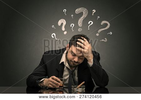Young drunk disappointed man with question signs concept