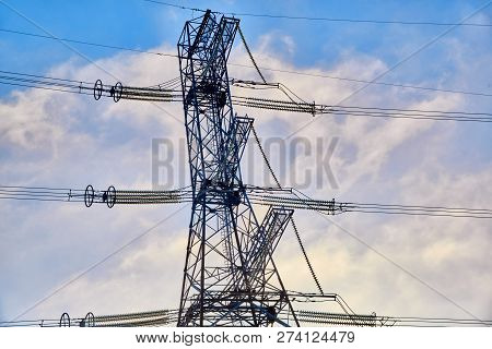 A Transmission Tower Or Electricity Pylon With Blue Sky. It Is A Tall Structure, Usually A Steel Lat