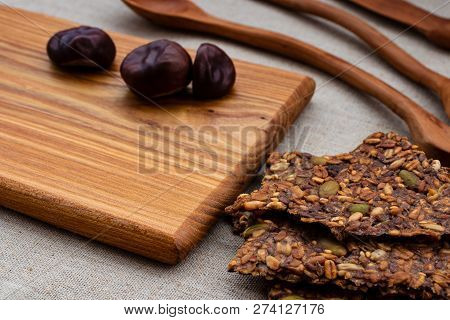 Toasts Of Grain And Seeds And Chestnuts On A Wooden Board With Wooden Spoons.