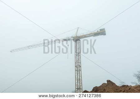 Tall Construction Crane In Fog Early Morning - Urban View
