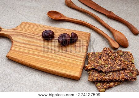 Toasts Of Grain And Seeds And Chestnuts On A Wooden Board With Wooden Spoons.