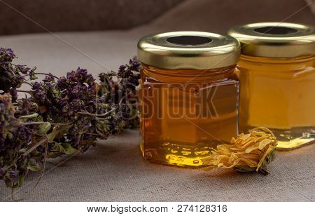 Honey From Different Flowers In Small Jars With Dried Summer Flowers.