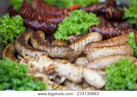 Delicious Grilled Sausages And Vegetable. Pork Sausages Fried In The Fire.