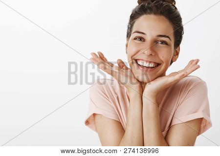 Pretty Confident And Gentle Young Stylish Woman With Bun Gesture Taking Care Of Skin Feeling Happy G