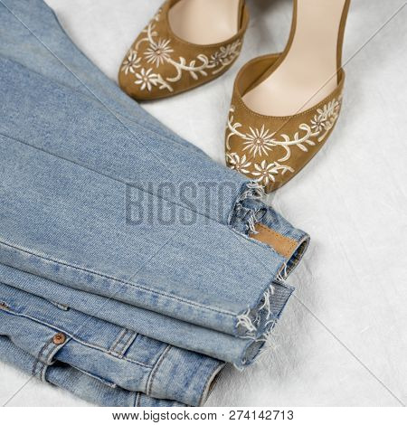 Fblue Jeans And Highheels Shoes With Embroidery Flatlay On A White Background