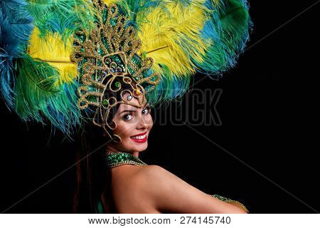 Brazilian woman posing in samba costume over black background