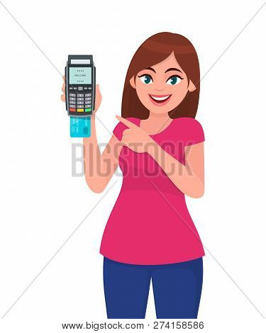 Young Woman Showing/holding Pos Payment Terminal Or Credit/debit Cards Swiping Machine And Pointing 