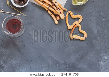 Many Orange Home Made Grissini Sticks With Pieces Of Black Olives On Baking Paper And Two Grissini H