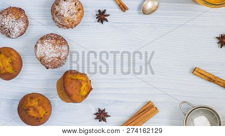 Six Home Made Bright Orange Yellow Pumpkin Muffins With Sugar Powder On Left Side Of Horizontal Bann