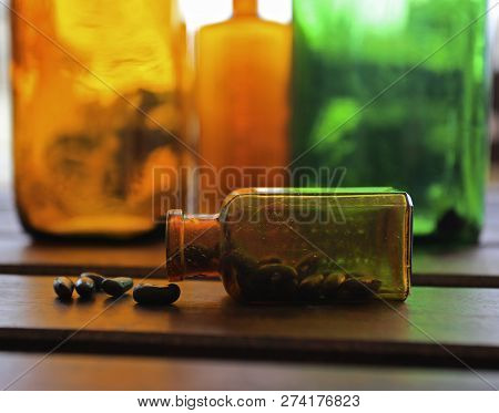 Amber And Green Colored Glass Bottles With Mysterious Contents