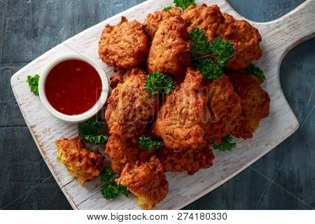 Crispy Onion Bhajis With Sweet Chilli Sauce On White Wooden Board