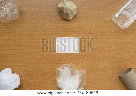 Top View Of Recycling Garbage Waste On Wooden Background With Center Copy Space , Eco And Save World