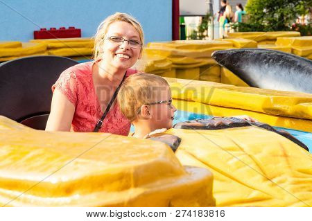 A Caucasian Mother And Her Son Enjoying At Amusment Park