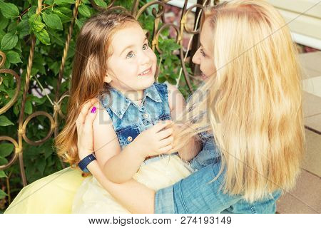 Mom And Her Little Daughter Cute Each Other, Close-up Portrait