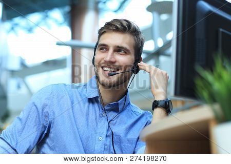 Smiling Friendly Handsome Young Male Call Centre Operator.