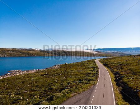Aerial View. Road Crossing Hardangervidda Mountain Plateau, Clouds Over Lakes, Morning Time. Norway 