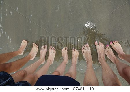 Ten Feet Of A Family Of Five On The Beach By The Sea