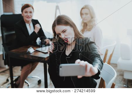 Teenage Girl In Leather Jacket With Upset Mother Taking Selfie In Psychologist Office. Punk In Lathe