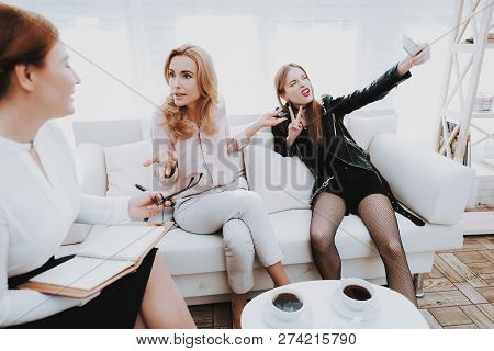 Teenage Girl In Leather Jacket With Upset Mother Taking Selfie In Psychologist Office. Punk In Lathe