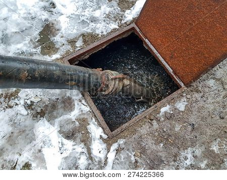 Emptying The Septic Tank With A Sewage Cleaner Machinery At A Residentual House.