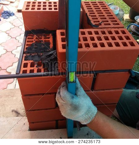 The Wizard Uses A Manual Level To Measure The Freshly Welded Wall