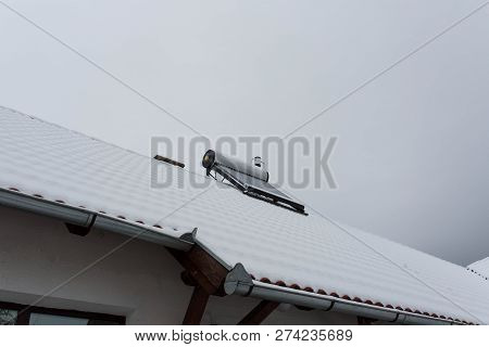 Empty Solar Water Heater Boiler On Residentual House Rooftop At A Cloudy Cold Winter Day.
