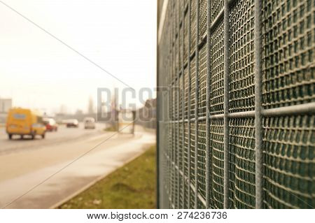 The Road Is Protected Against Noise Emission By Noise-absorbing Barrier (also Called A Soundwall, No
