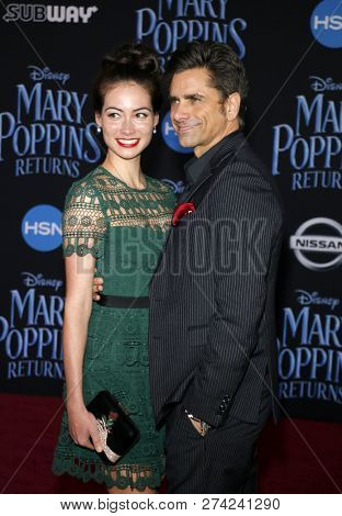 Caitlin Mchugh and John Stamos at the World premiere of Disney's 'Mary Poppins Returns' held at the Dolby Theatre in Hollywood, USA on November 29, 2018.