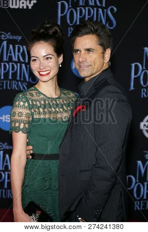 Caitlin Mchugh and John Stamos at the World premiere of Disney's 'Mary Poppins Returns' held at the Dolby Theatre in Hollywood, USA on November 29, 2018.