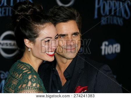 Caitlin Mchugh and John Stamos at the World premiere of Disney's 'Mary Poppins Returns' held at the Dolby Theatre in Hollywood, USA on November 29, 2018.