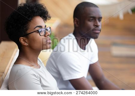 Serious African American Woman Sitting In Cafe, Looking In Dista