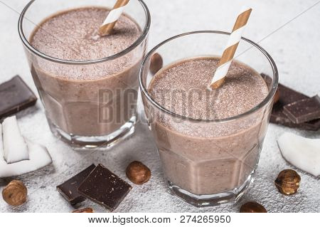 Chocolate Coconut Hazelnut Milkshake Or Smoothie In Two Glasses On White Table. Close Up.