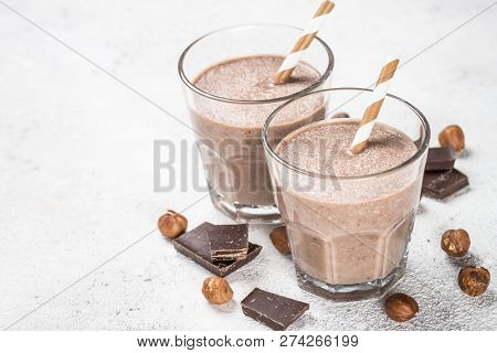 Chocolate Coconut Hazelnut Milkshake Or Smoothie In Two Glasses On White Table.