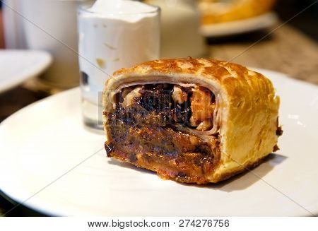 Strudel With Prunes, Dried Apricots And Nuts Lying On A Plate.