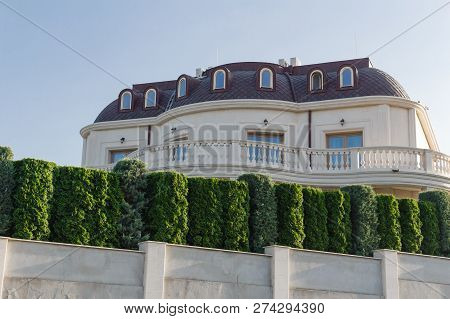 Keeps Privacy And Security Concept. Big Luxury House Behind The Green Fence In Byala, Bulgaria.