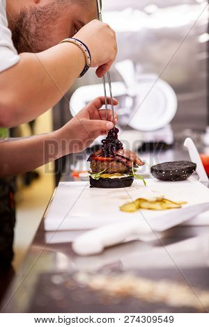 Chef Performs How To Make Proper Buger