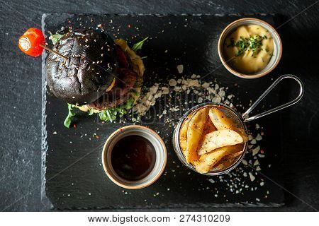 Delicious Black Beef Burger With Soia Sos And French Fries