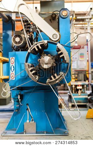 Cold Rolled Steel Coil On Decoiler Of Machine In Metalwork Manufacturing. Modern Equipment For Sheet