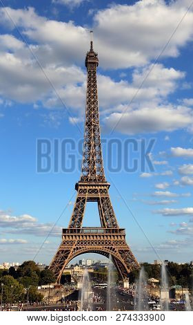 Eiffel Tower Symbol Of In Paris City In France With Clouds Seen From Trocadero Area With Fountain