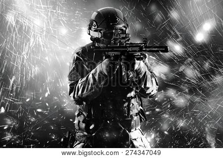 Fighter Of A Special Unit Is Aiming At The Sight Of The Machine Gun. Mixed Media